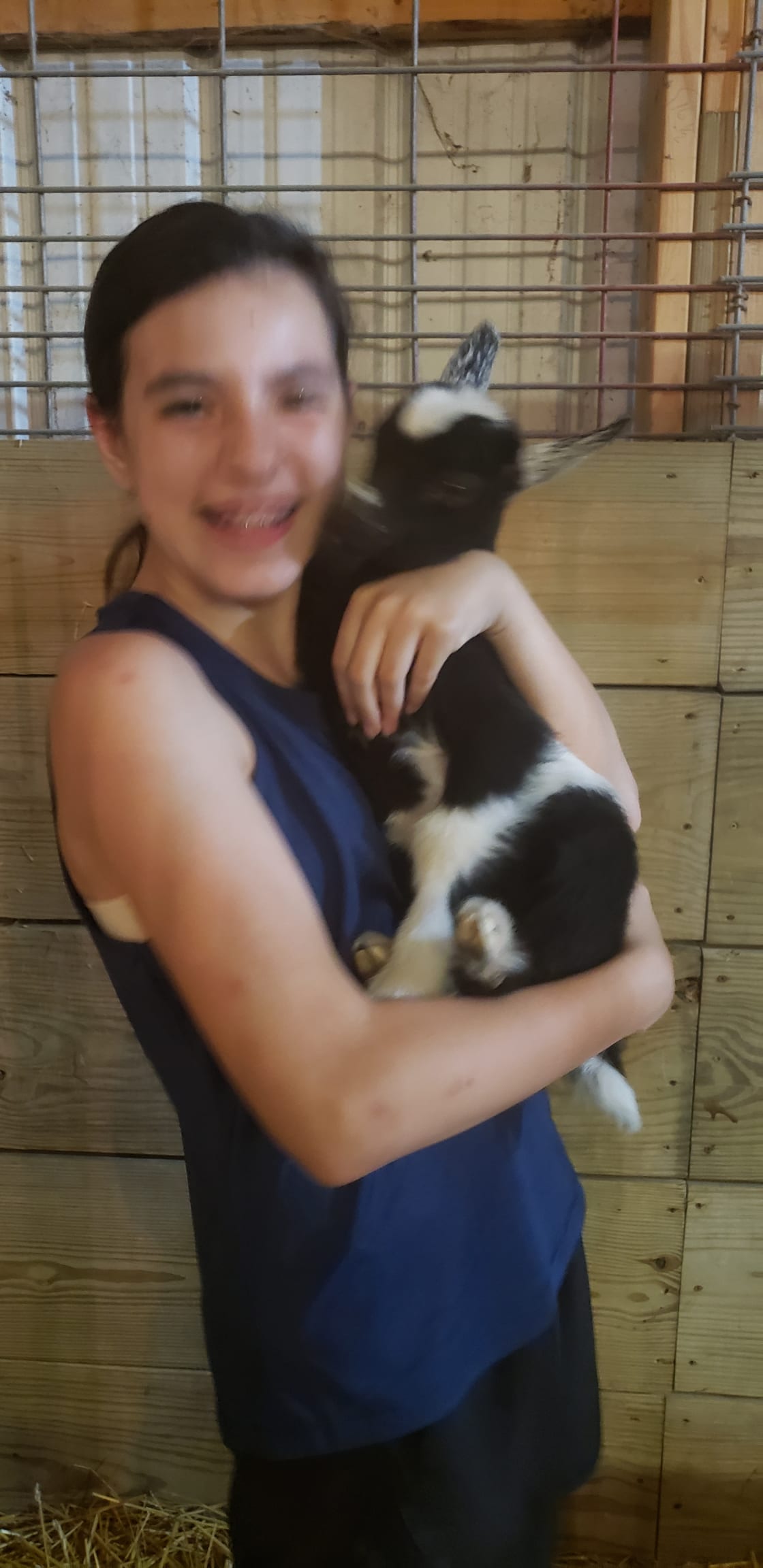 Reagan hugging new baby goat at the farm