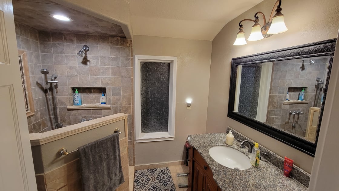 Full bath with walk-in shower, with the toilet behind the door, and tankless water heater for nearly unlimited hot water.