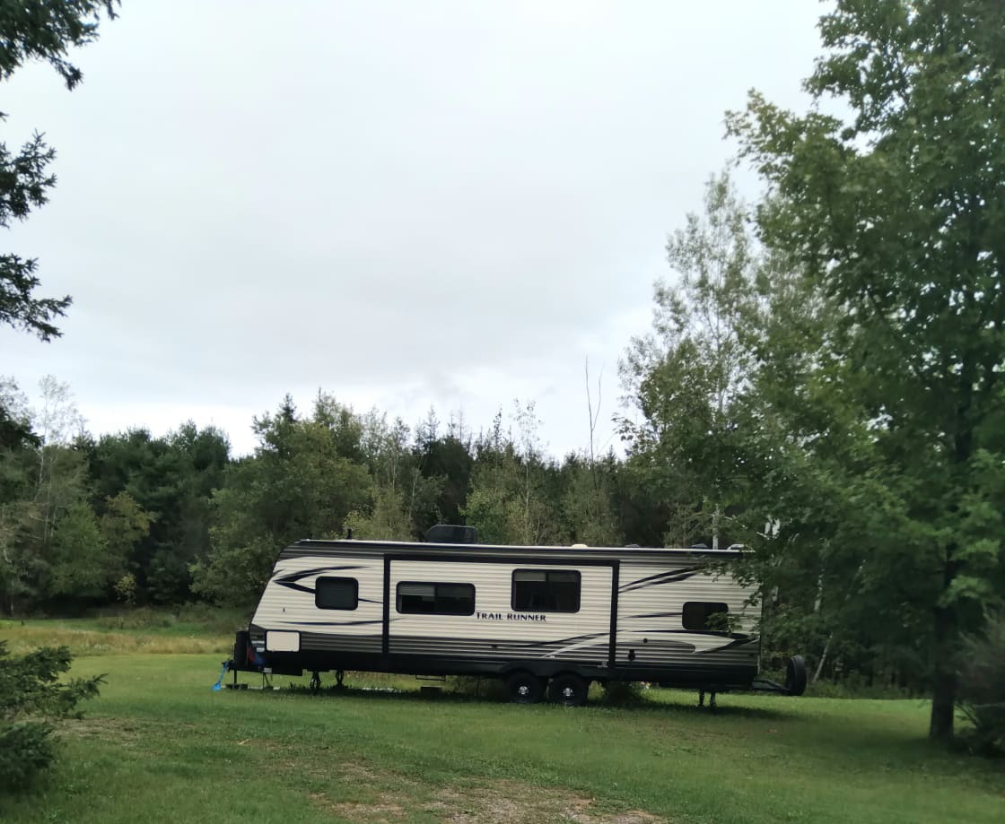 This is a 2018 large RV.  Bunk Beds and a bigger BED at the other end.  Plus kitchen table can become a 5th bed!   No water at this time but near house for showers.