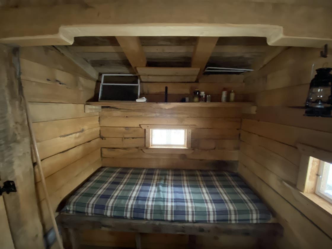 Inside tiny cabin, sleeping area.