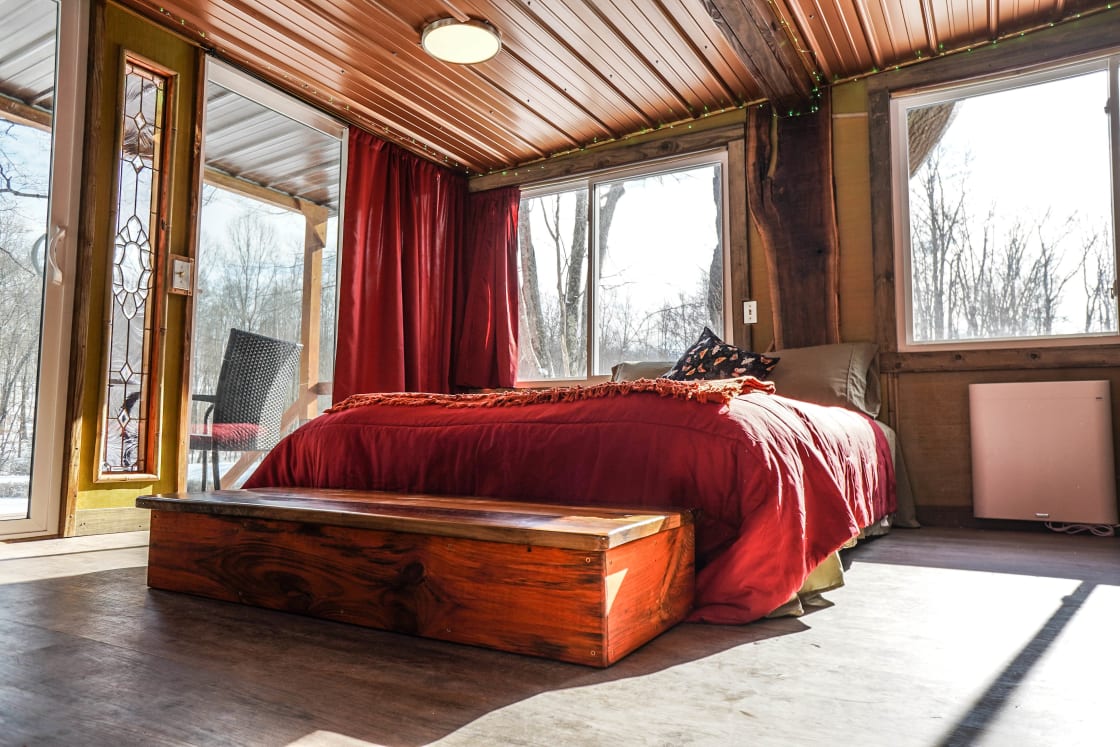 See the queen size bed, seven windows and two sliding glass doors.