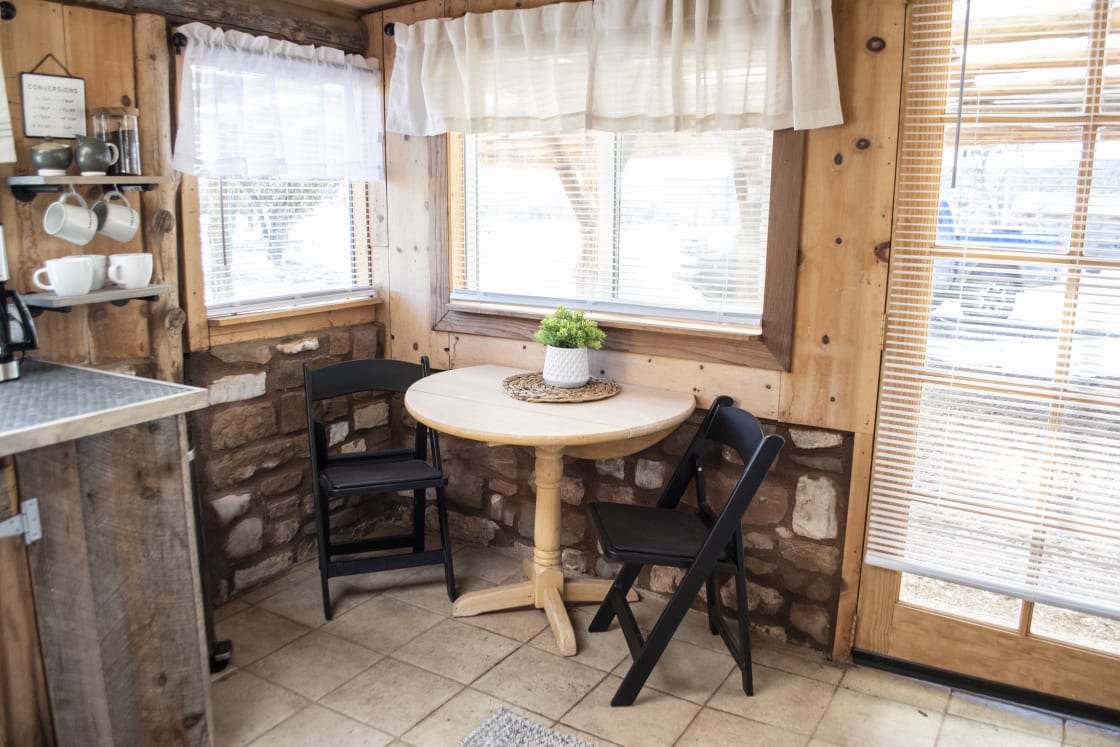 Small dining area beside the front door.  The table has sides that fold up or down, so you can easily open it all the way and move it to the center of