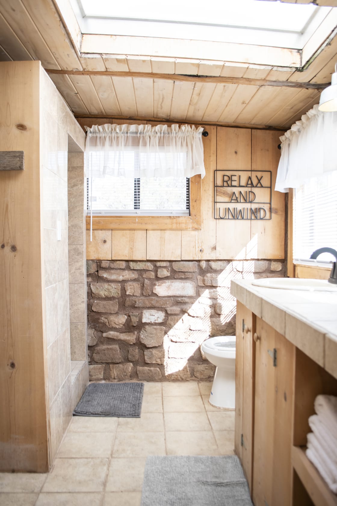 The bathroom has a large walk-in shower and YES...there's hot water! :) Large countertop area.  Basic cleaning supplies are stored in a closet area. P