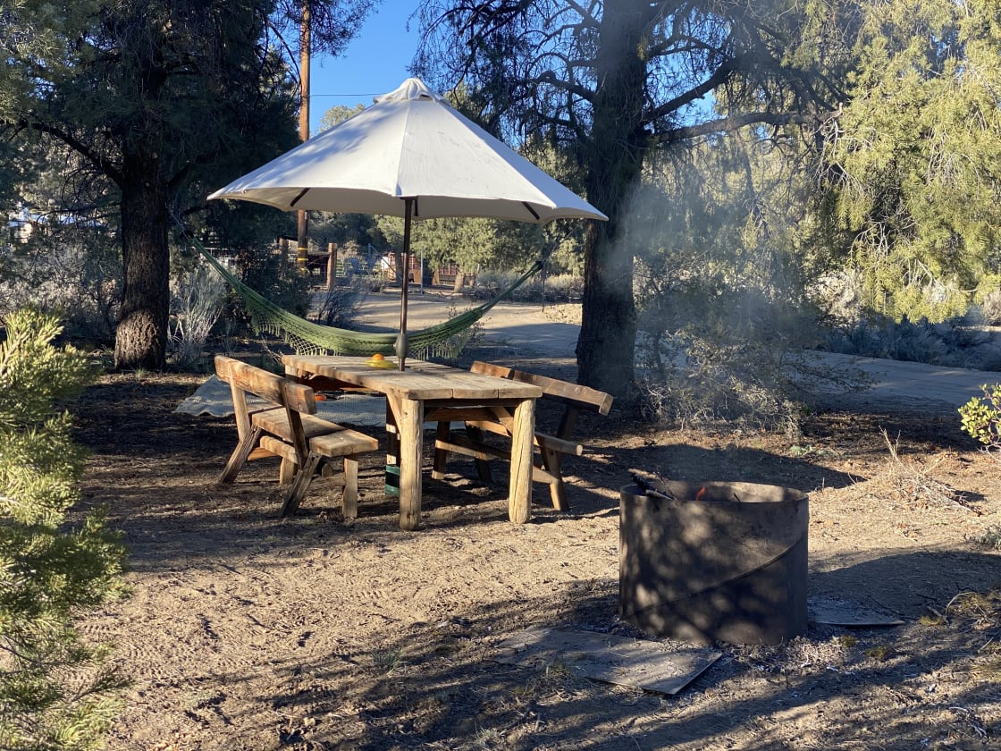 Steel ring fire pit, large picnic table, hammock spot under the large piñon pines. 