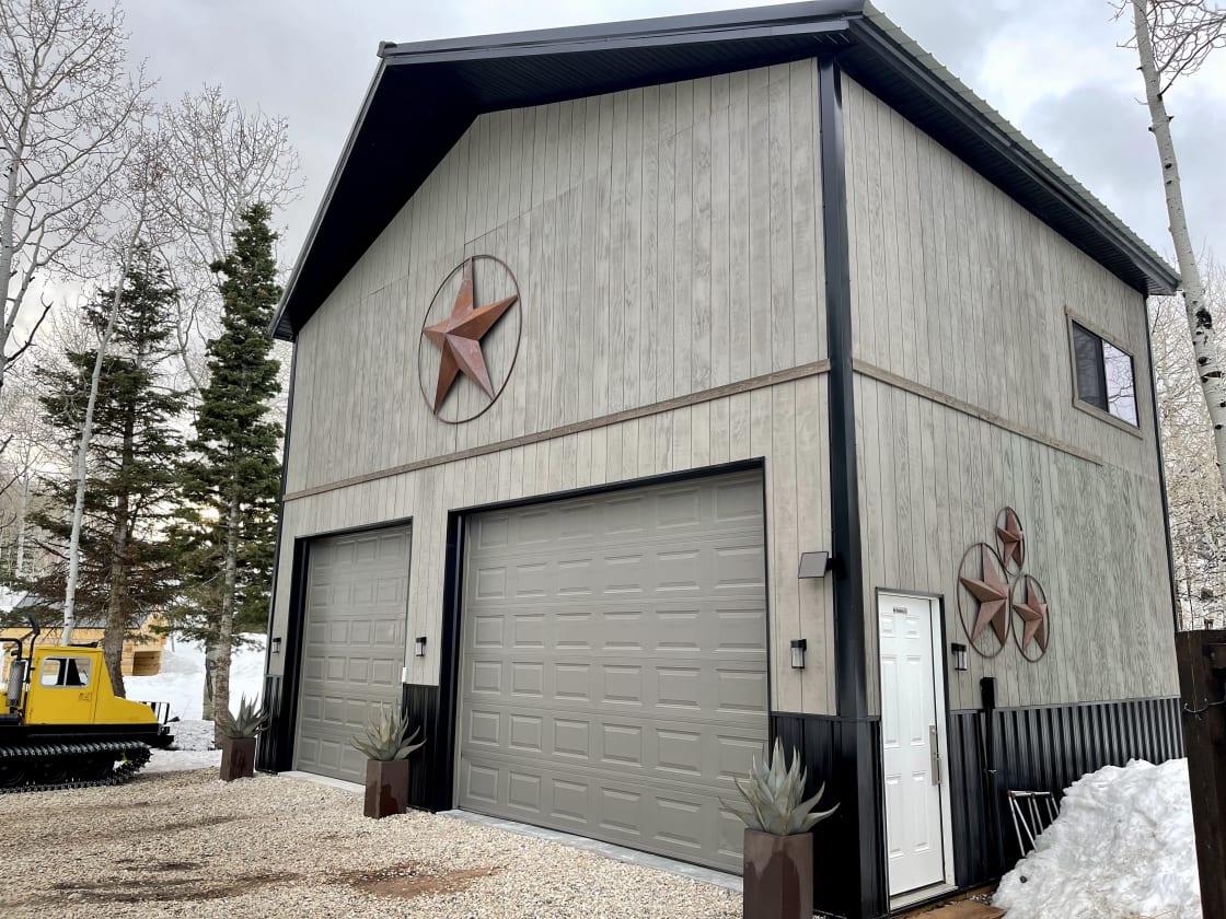 28’ tall pole barn custom built by your hosts Lee & Amber w/Snowcat parked on the side!