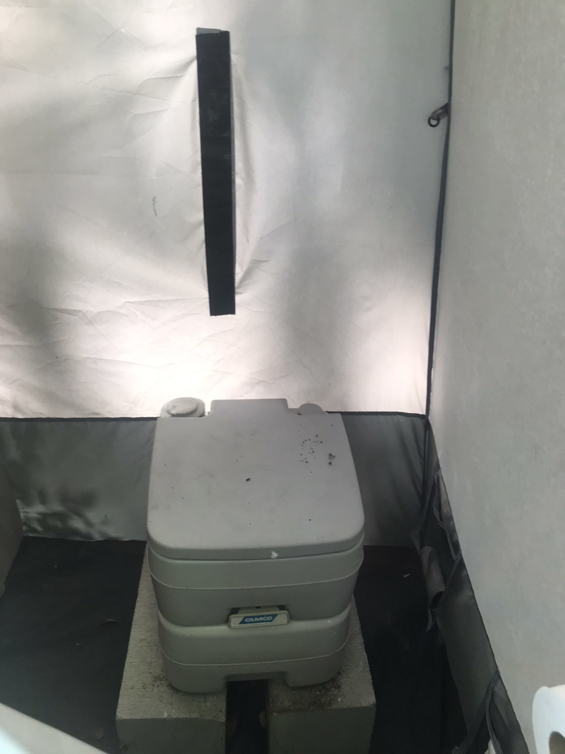 Portable toilet in shower house