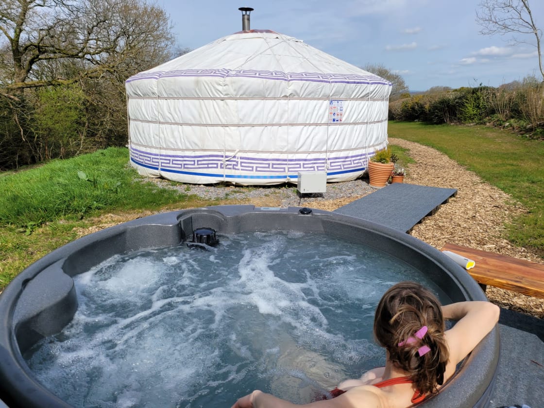 Hot tub hidden behind the yurt so you can relax in peace and enjoy the sound of the stream and the birds
