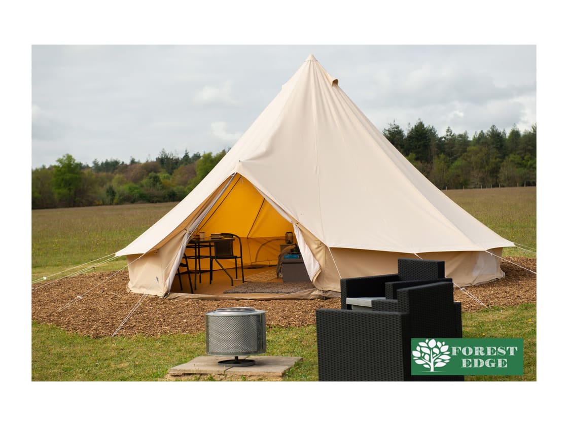 Fully Furnished Bell Tent with outdoor furniture and firepit