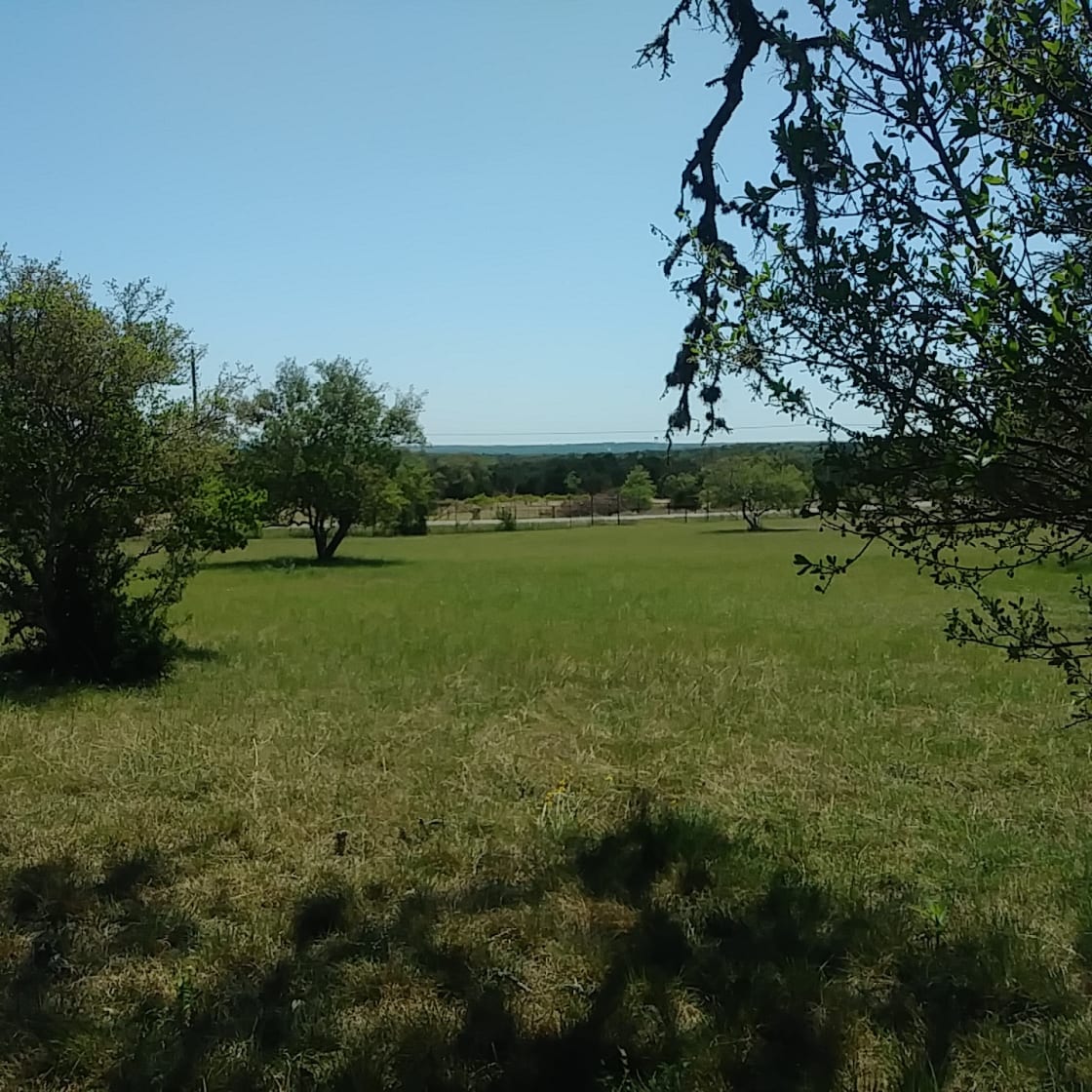 The meadow at the front of the property with a view of the Wimberley Valley