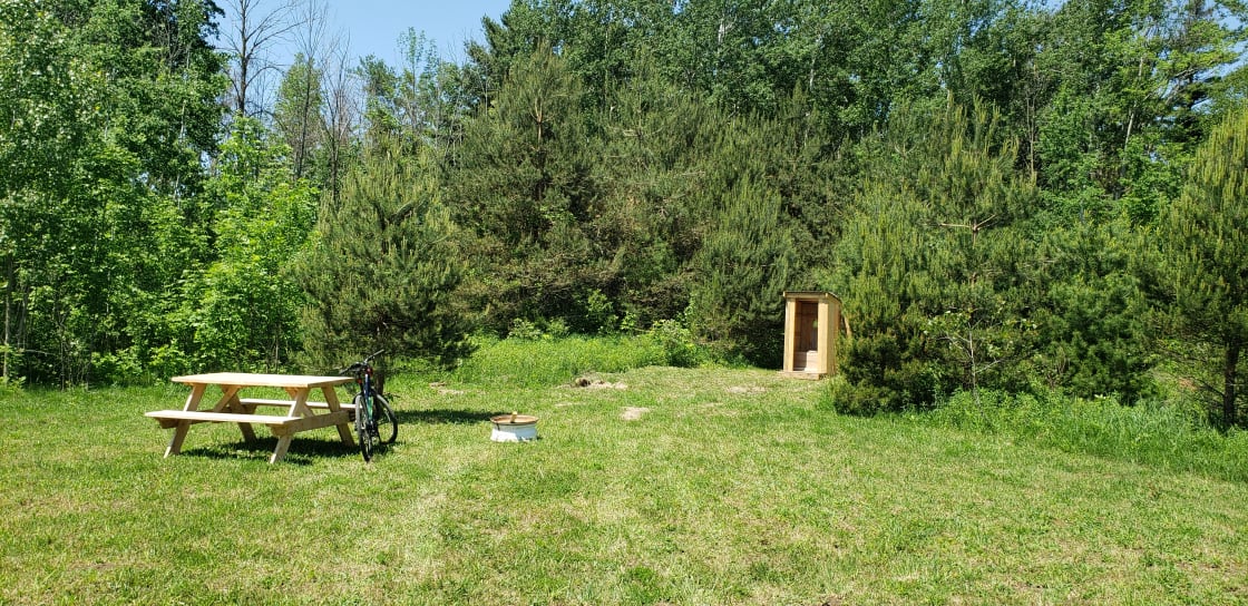 Here is a pic of our new outhouse, picnic table and fire pit.