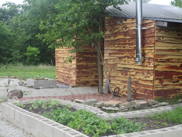 community garden and tumbling composter outside bunkhouse