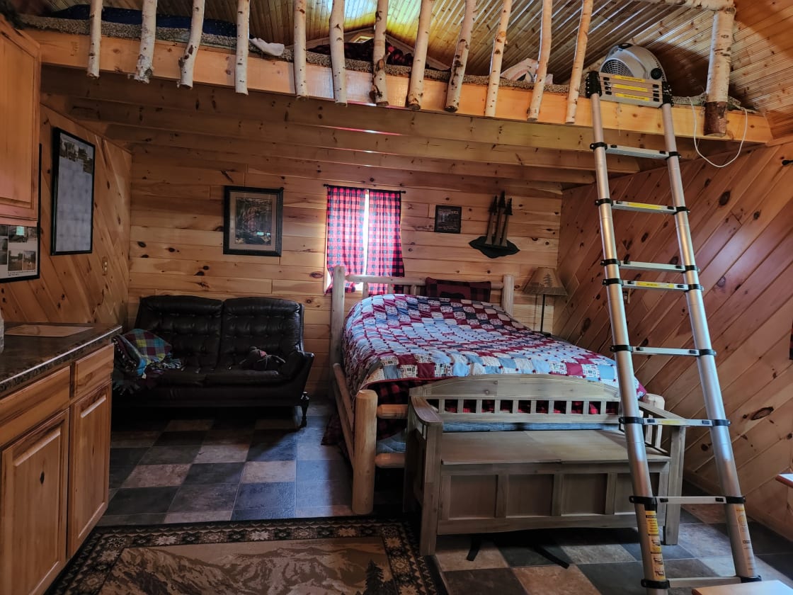 Cabin 2 with queen bed and loft above. This loft has 1 King size mattress. loft above door has 2 full mattress. 