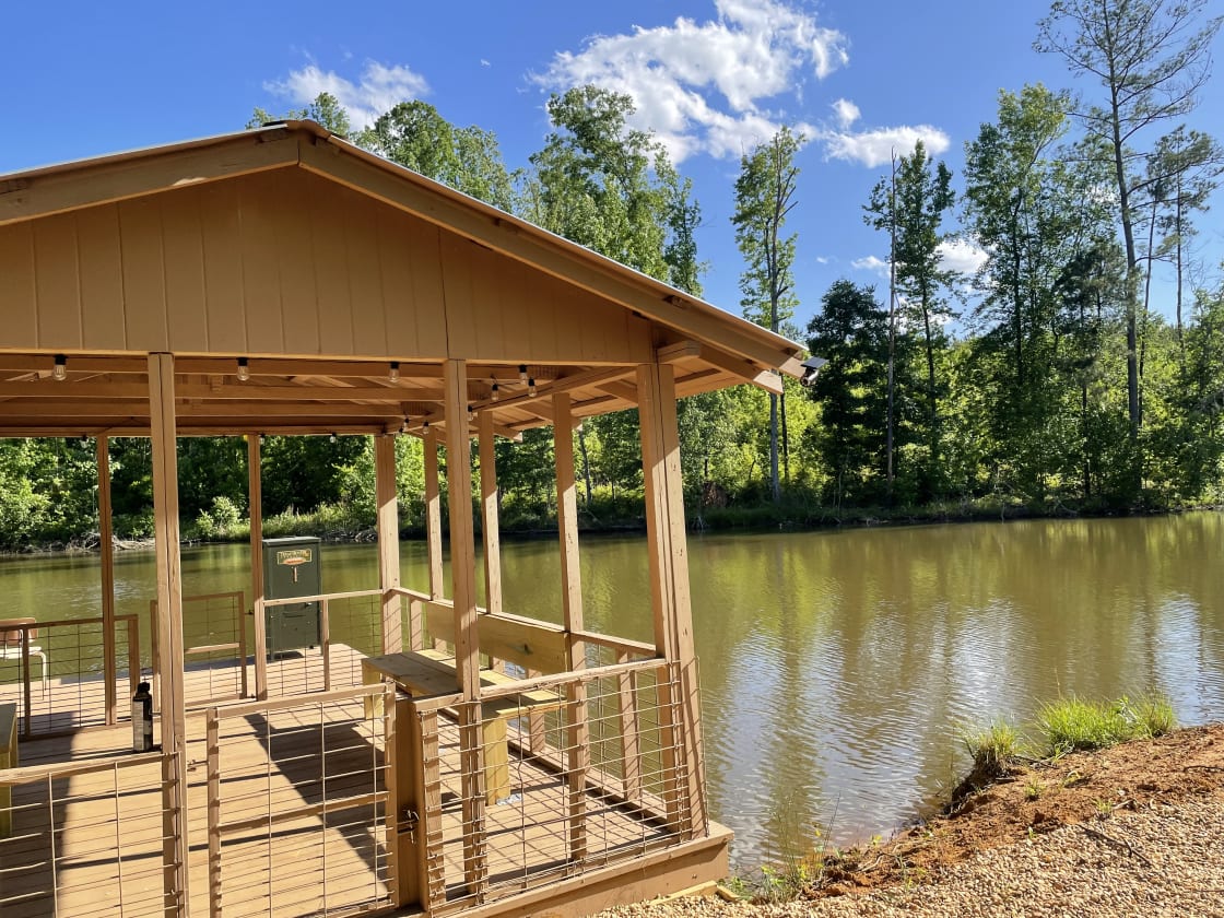Covered Fishing boat dock with automatic fish feeder located on the private 1.5 acre lake
