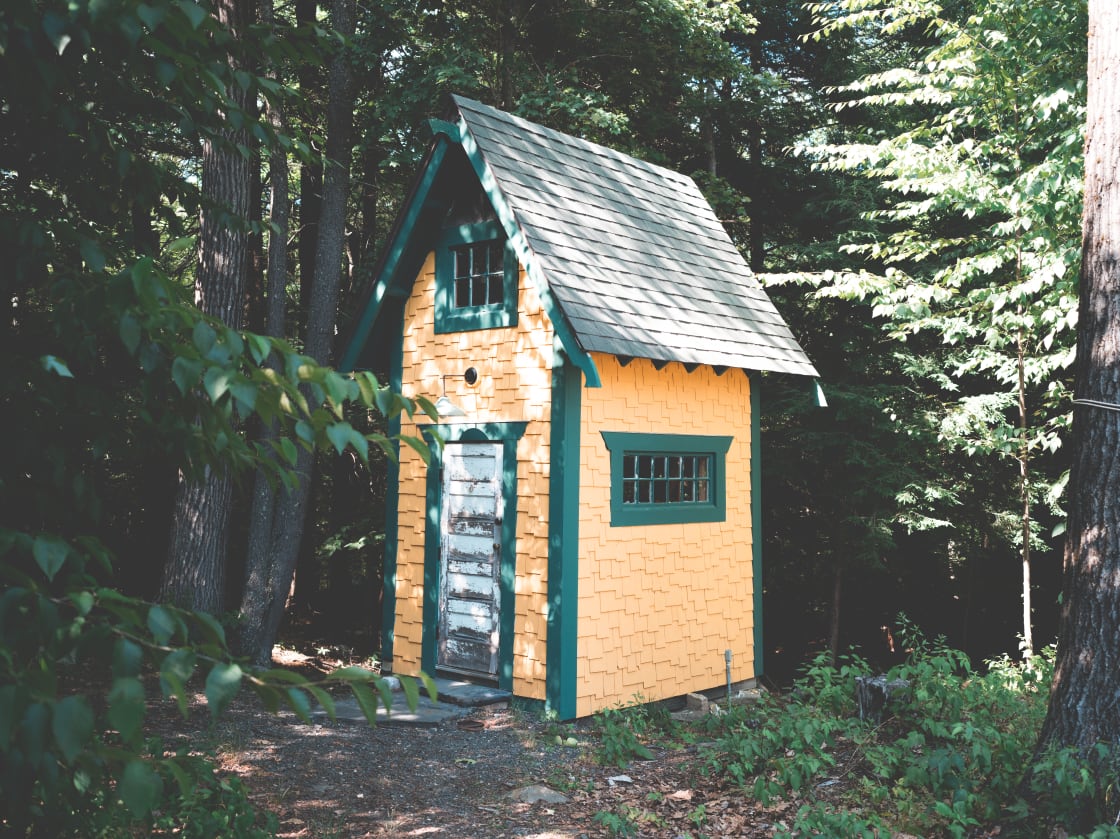 two story tiny cabin with two windows on bottom floor and two screened windows on top floor that can open 