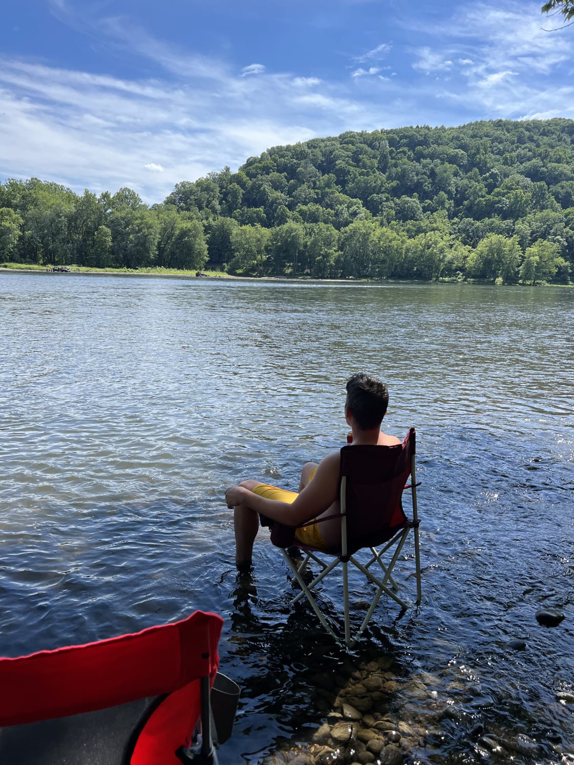 The locals know the best way to enjoy the river is to plop your chair down in the water and watch the boats go by.