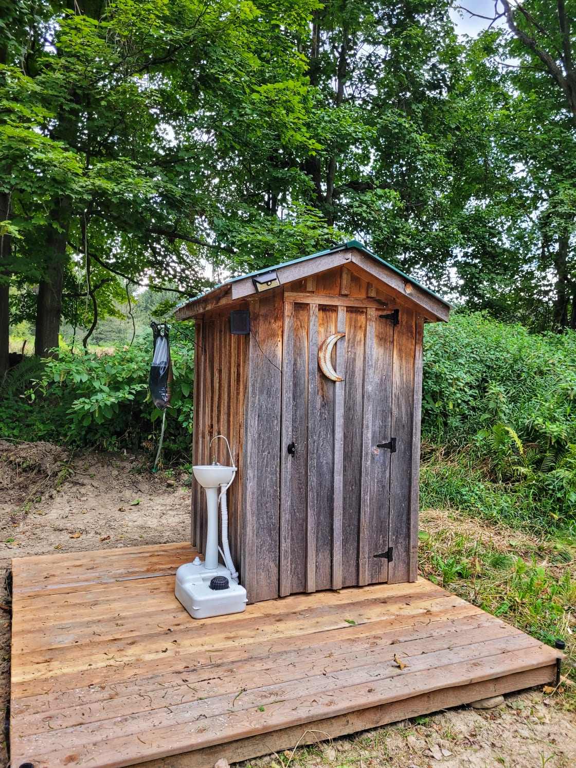Primitve outhouse available for use, with pump hand wash station and gravity cold water shower. 
Has solar and battery lights. 