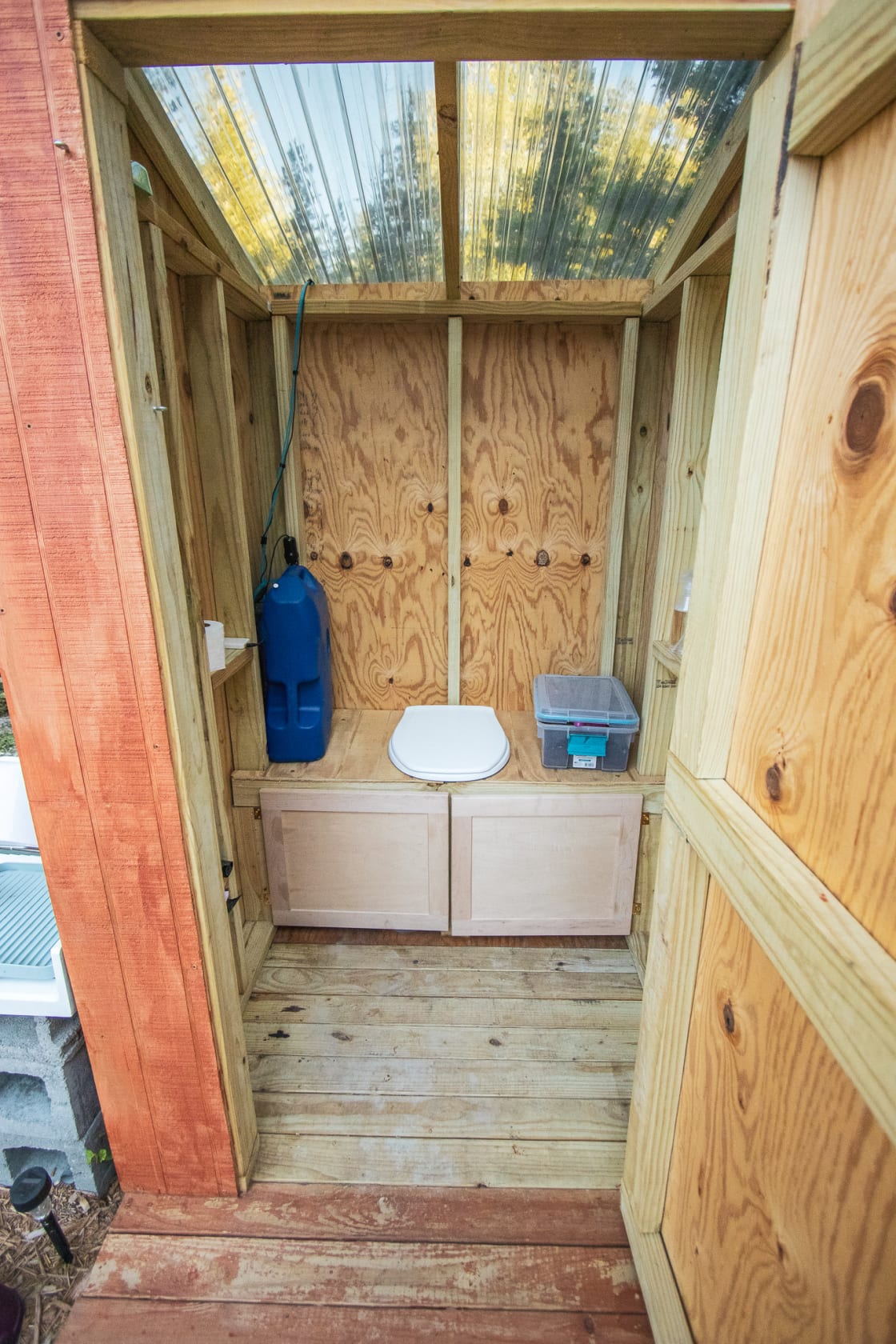 Inside the outhouse that has a composting toilet
