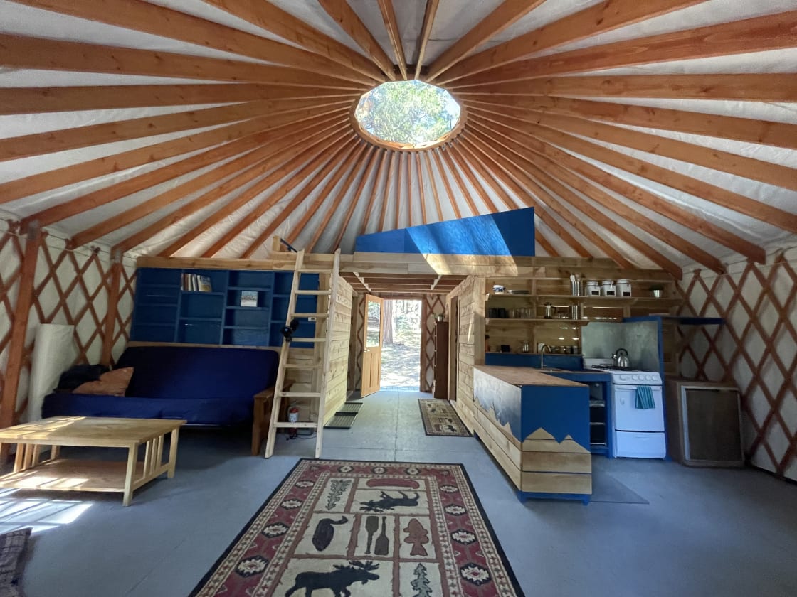 Very spacious 24' yurt with a full (dry) kitchen, battery powered lights, and a futon for a couple extra guests.