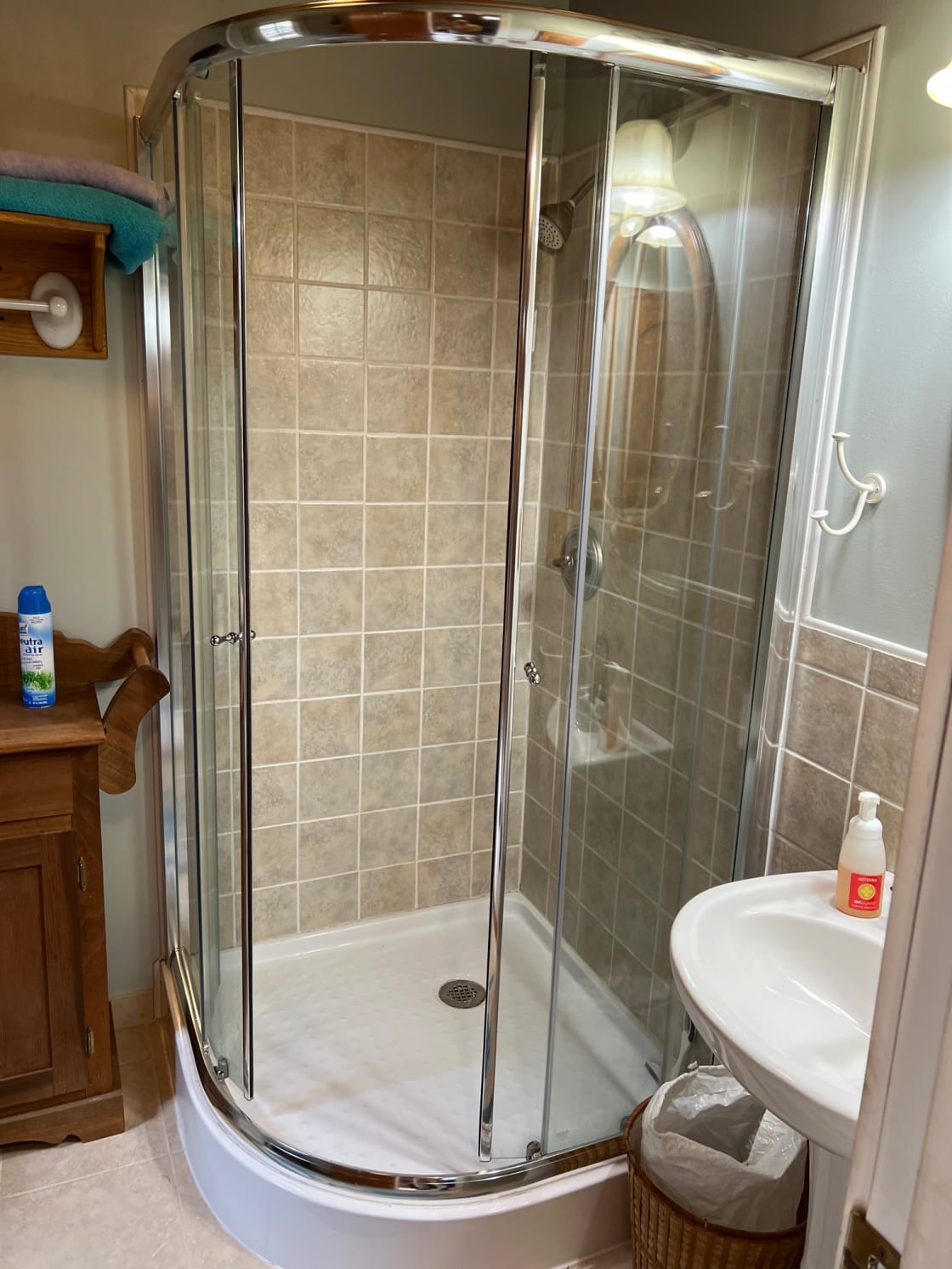 Bathroom showing shower and small sink