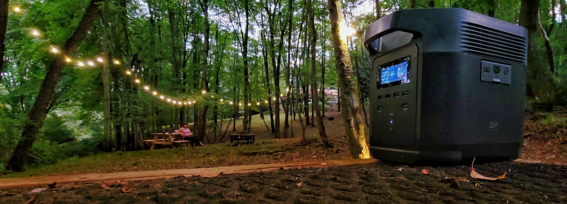 Campsite lit by provided battery generator