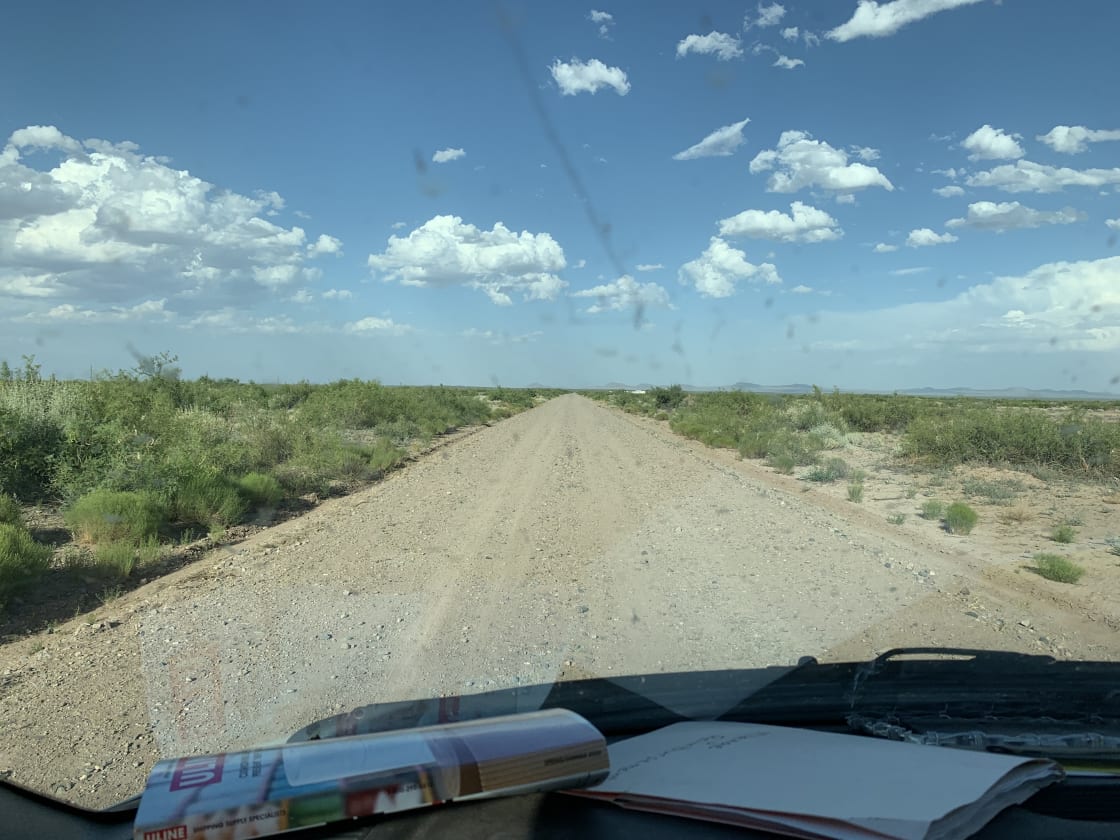The road coming in is narrow and lined with mesquite bushes.