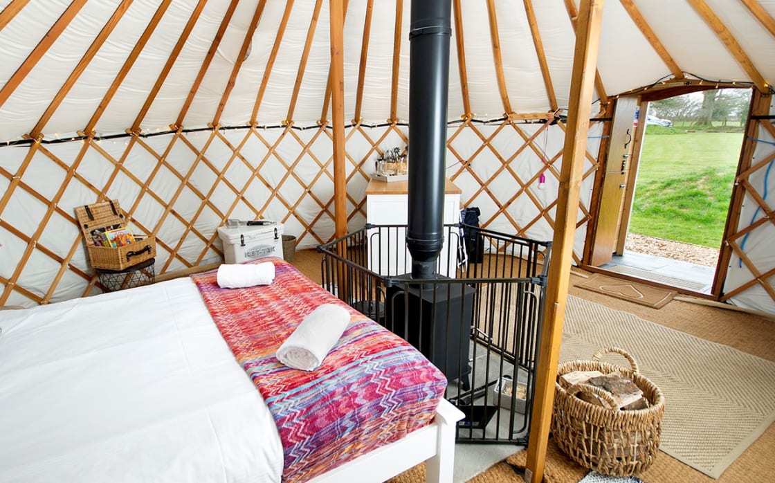 Inside your yurt, comfortable double bed, wood burning stove, kitchen area
