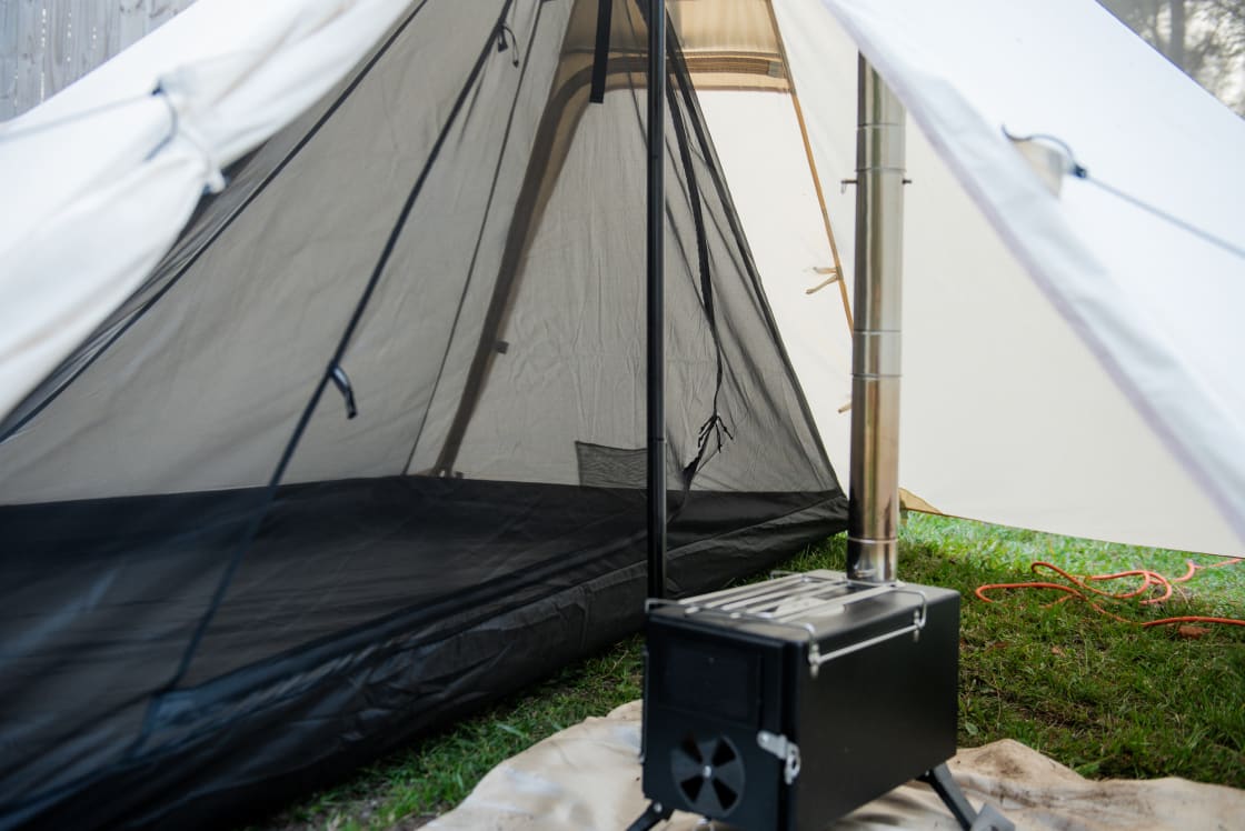 Inside the canvas tent there is a small wood burning stove that keeps you cozy through the night