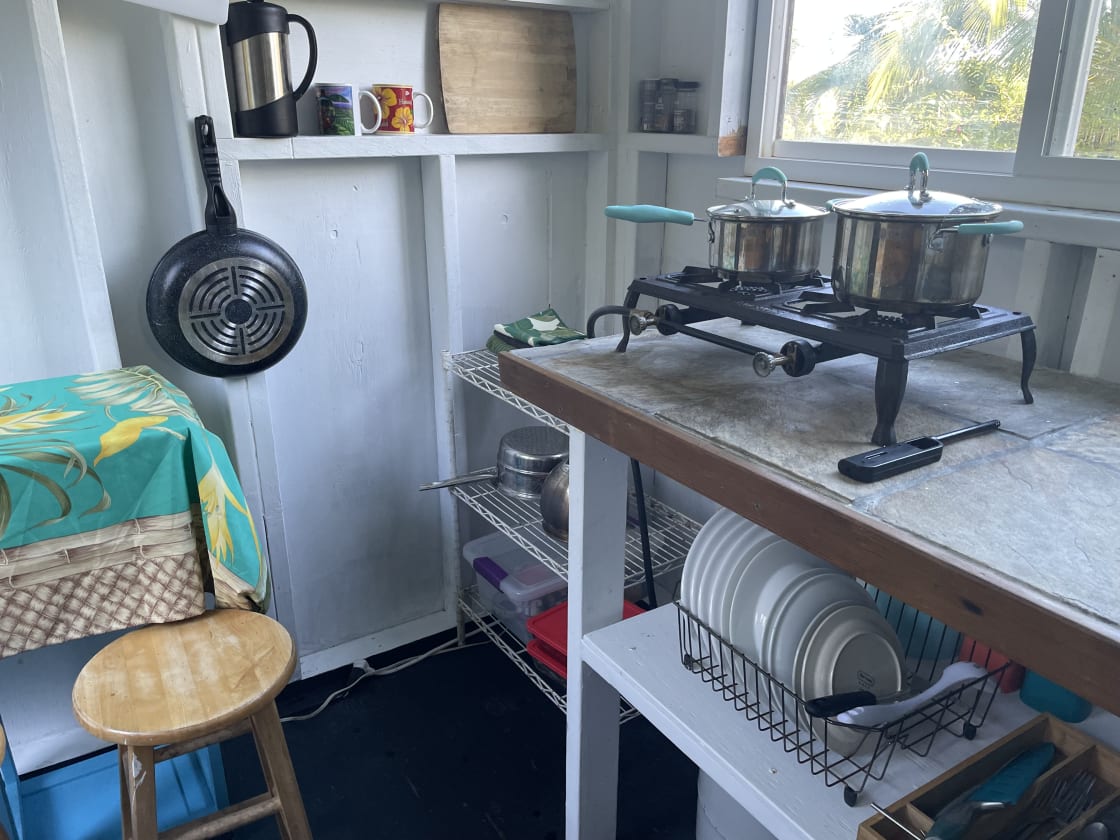 Separate kitchen with two burner stove, electric cooler and the basics.
