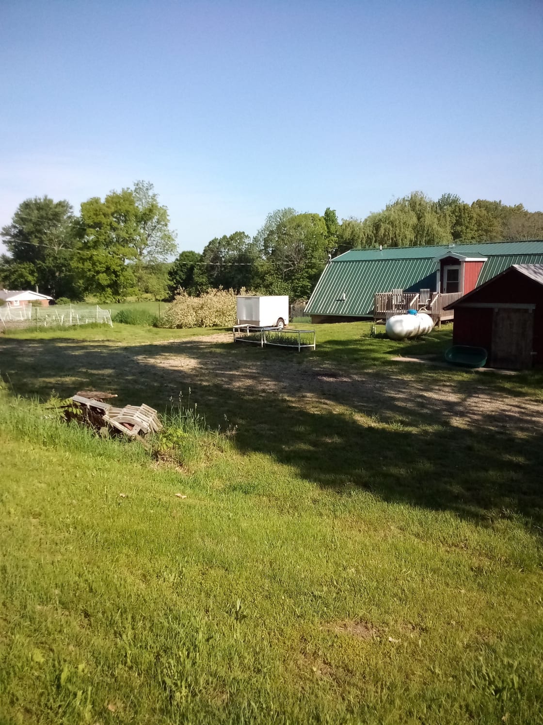 Overview of backyard camping area.  Utility trailer is in camp site