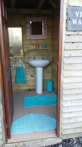 Vintage washroom with instant hot shower and flushing toilet