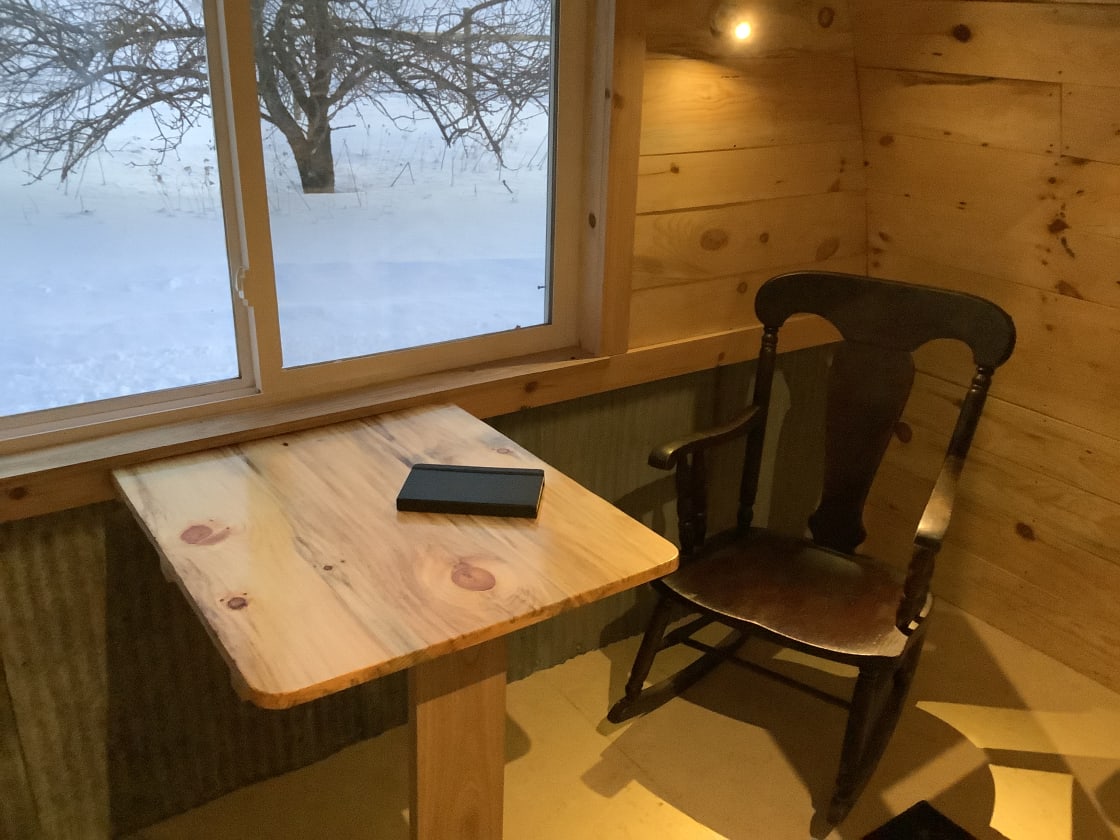 Fold down table is good for a small puzzle, card game or journaling with farm views out the window.