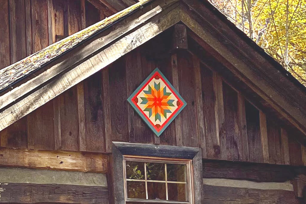 Our barn quilt was designed to represent two native plants of the Appalachian Mountains, flame azalea and fire pink.