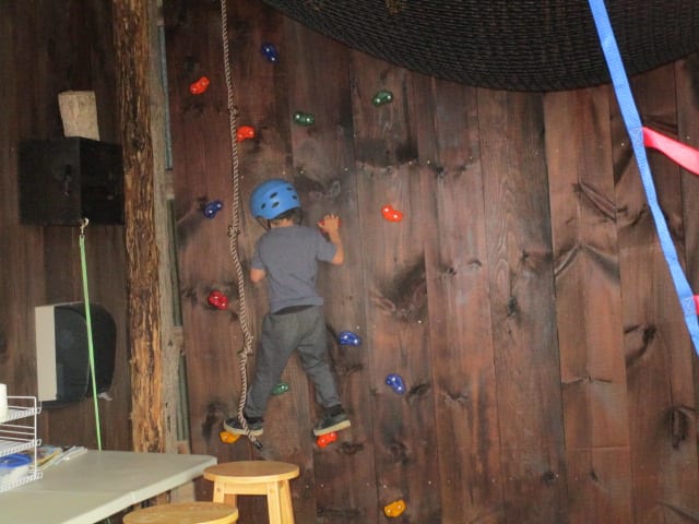 12' Climbing wall and climbing rope 10' x 10' net ( 400 lb limit ) hangs from the ceiling for climbing around in mid-air.