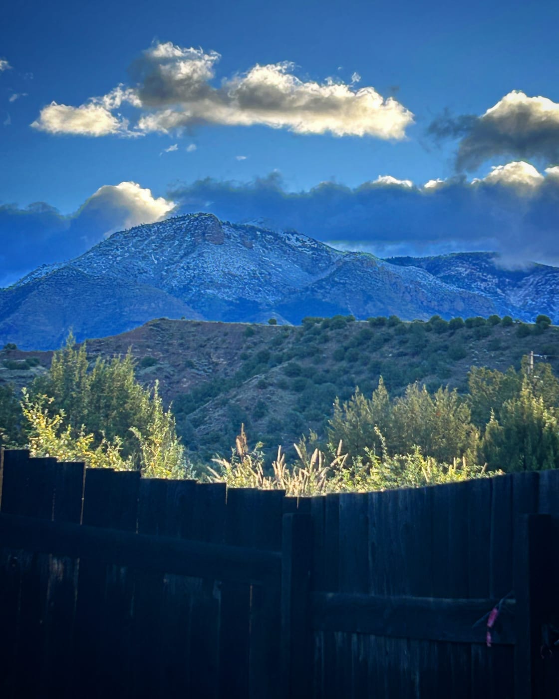 Privacy fencing along sides of camp. Mogollon Mountains in view.