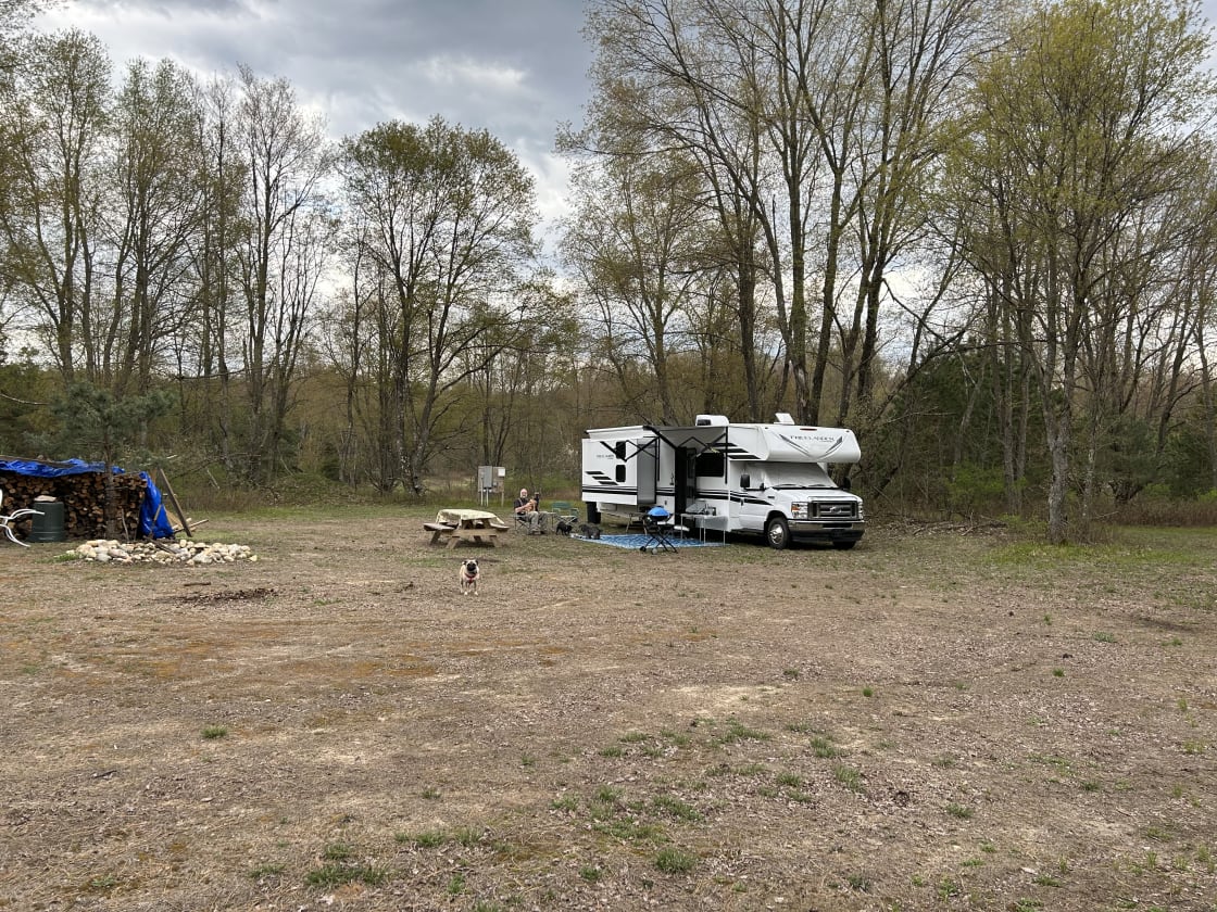 The site was flat, no need to level. Electricity and potted water available, as well as an outdoor heated shower. Nice open area for camping with lots trees and wildlife. Central fire pit, lots of wood and some picnic tables. 