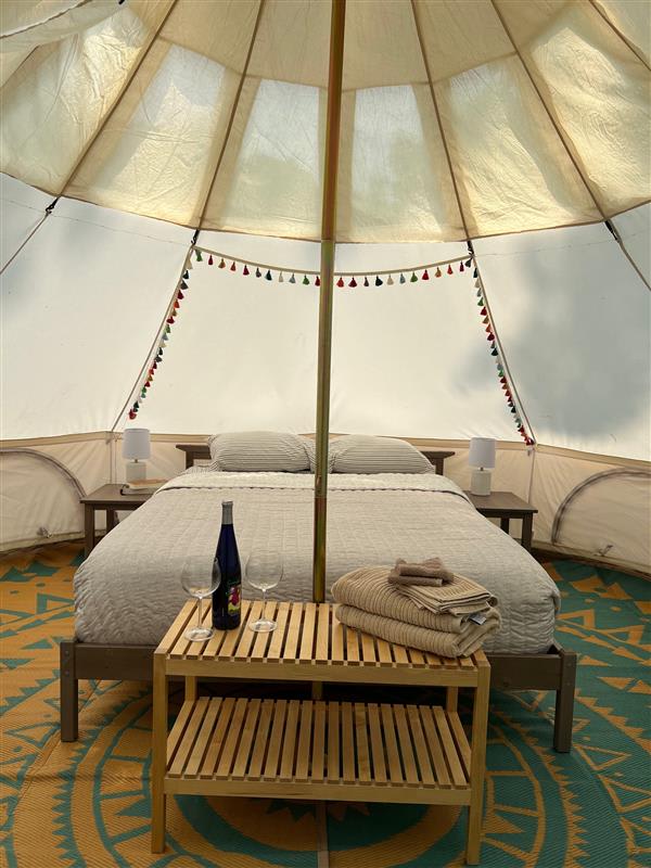 Interior of tent. Full size bed and full size sleeper couch with linens included. 