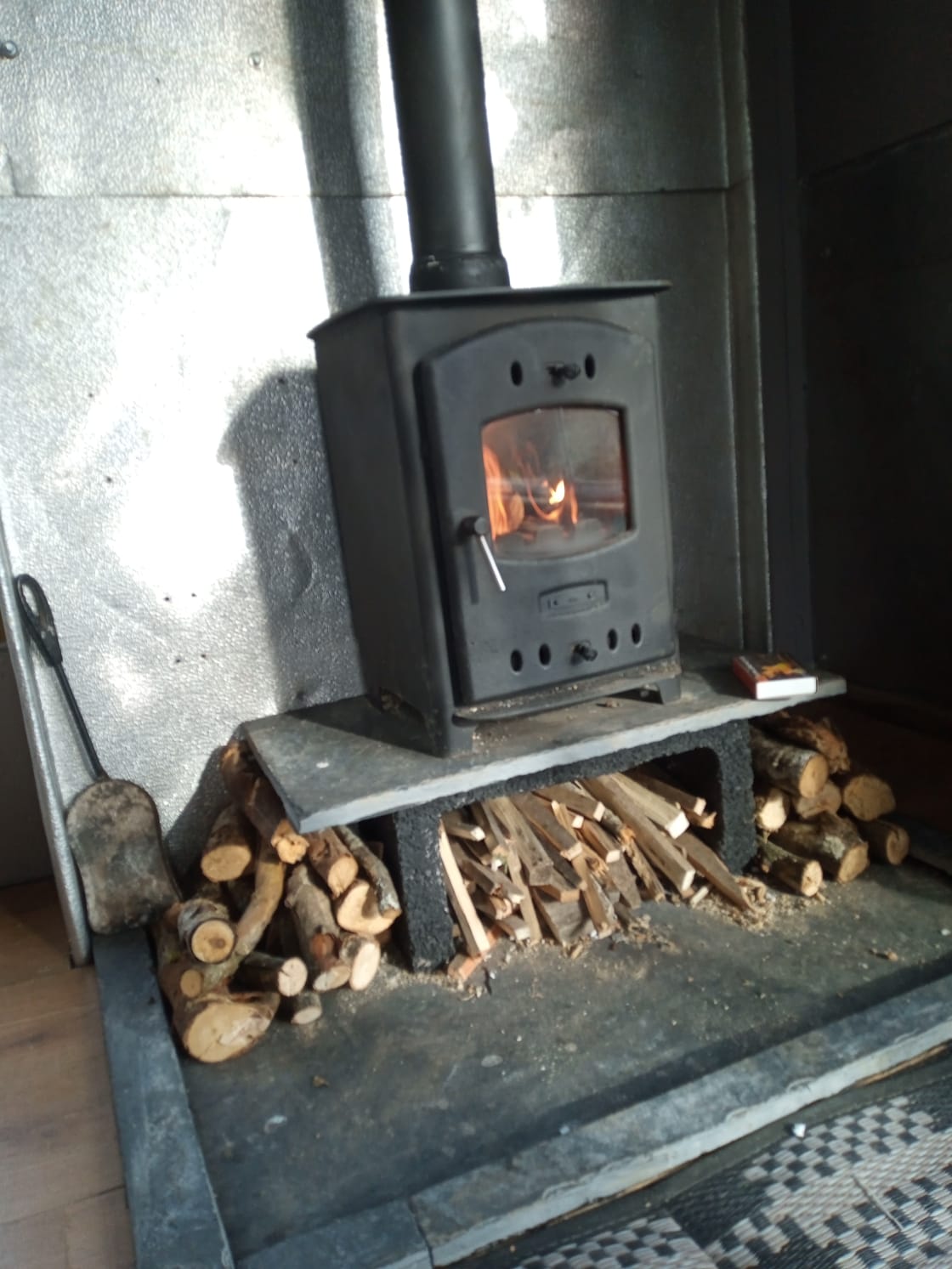 The lounge features a cosy log burner