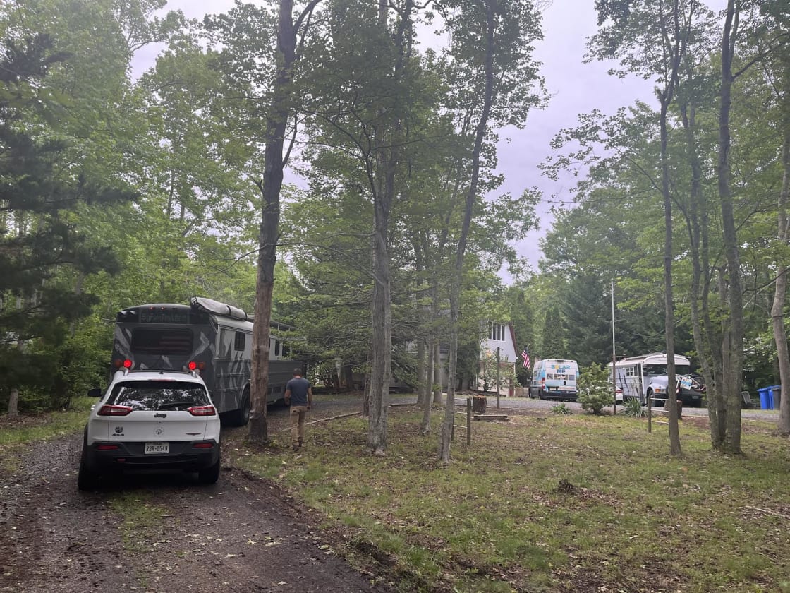 A 40-foot skoolie and their tow vehicle at That Dome Home RV Site