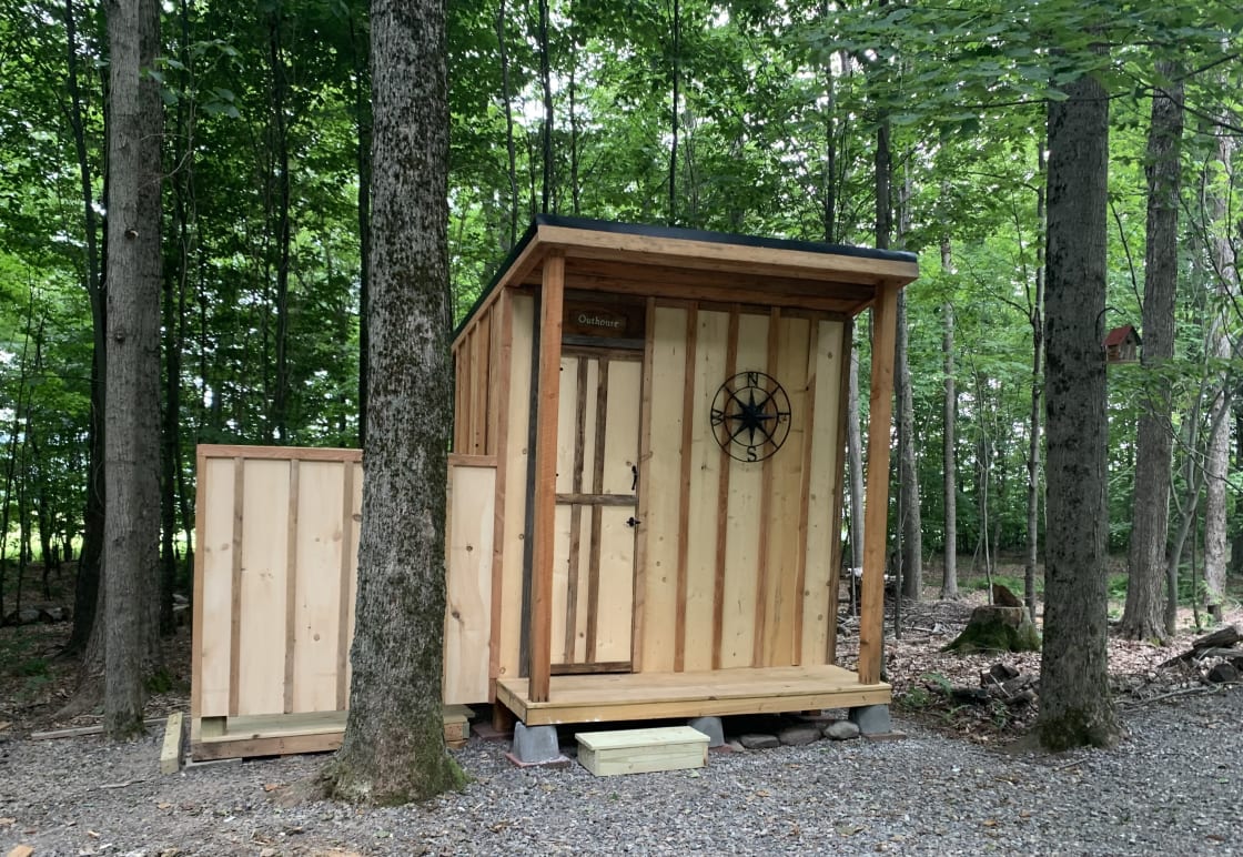 Outhouse with outdoor shower area.