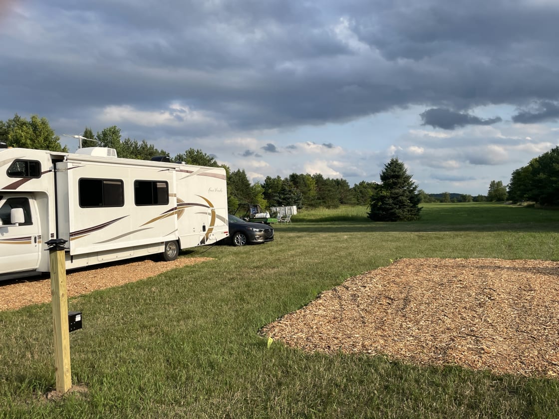 The RV is on Site One. It is closest to the barn and the fire pit. 