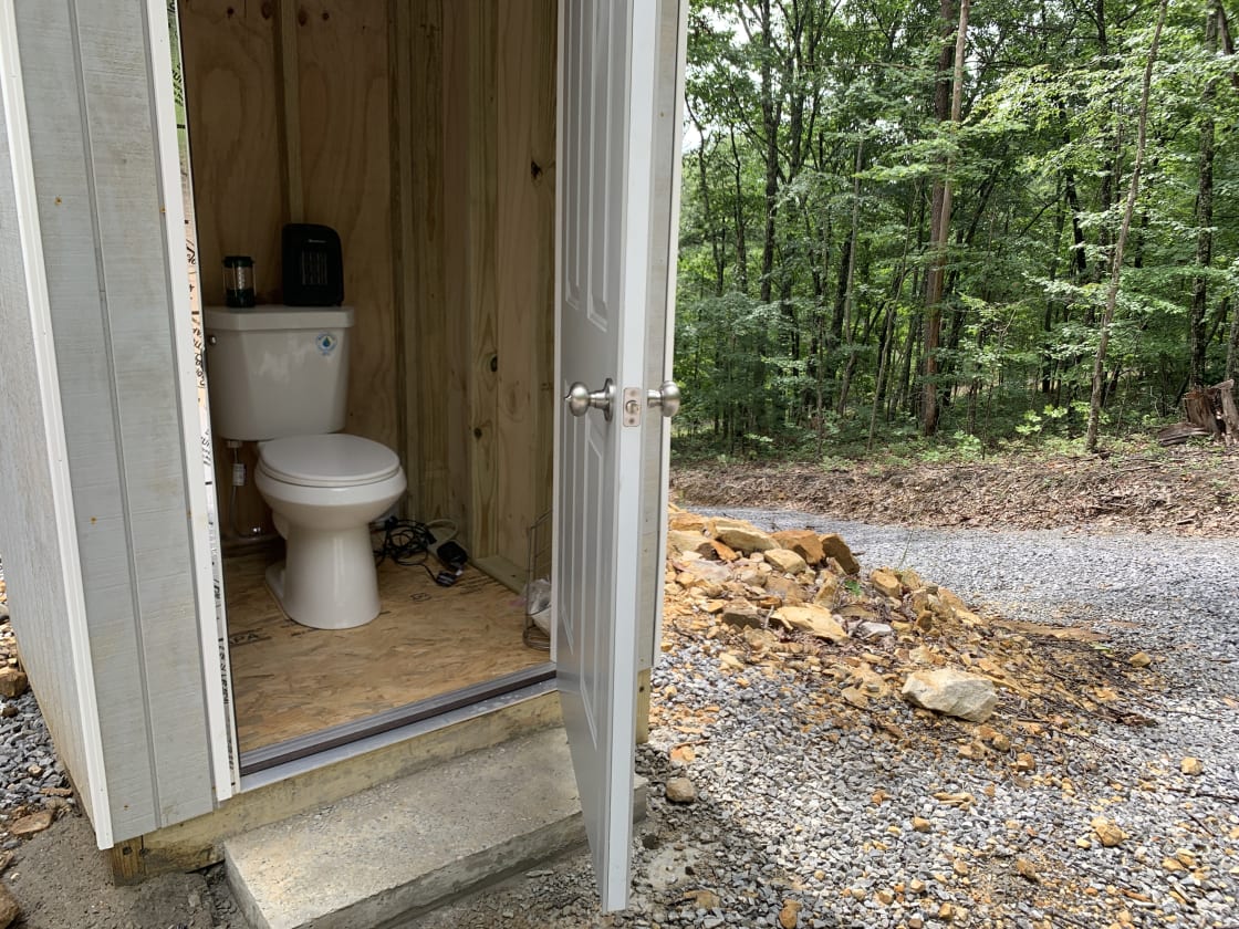 Unique rain barrel bathroom house. Note: steep hike up the gravel driveway to get to it, so camping potty provided at campsite.