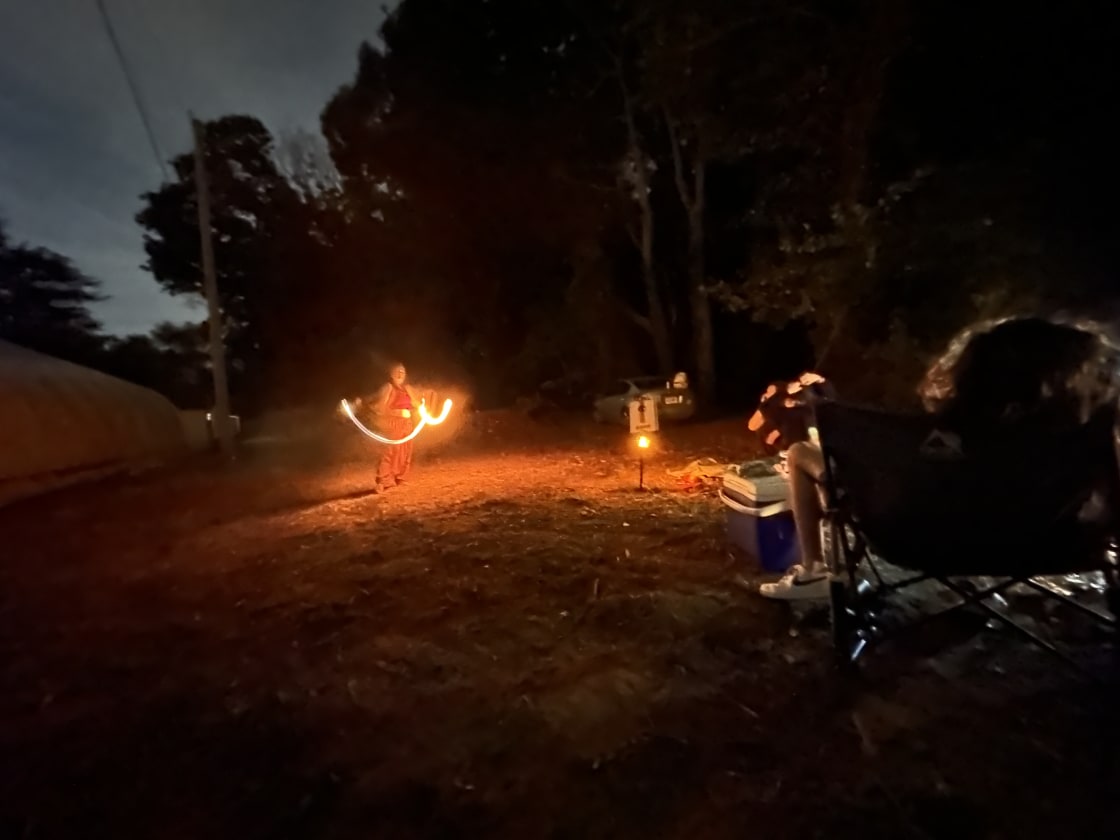 The area option is behind this Hipcamp customer performing her talent of fire spinner at near the communal area.
Park- Pick close to woods or close to white outbuilding