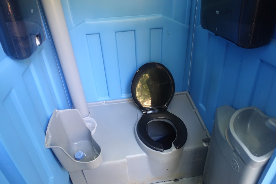Porta Potty with sink, paper towels and toilet paper