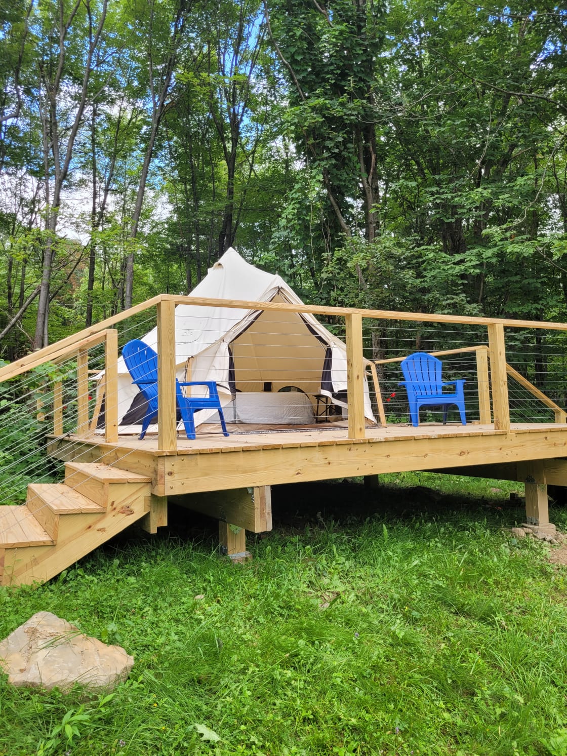 A beautiful platform deck for surveying the woods, pond, and sky around the tent.