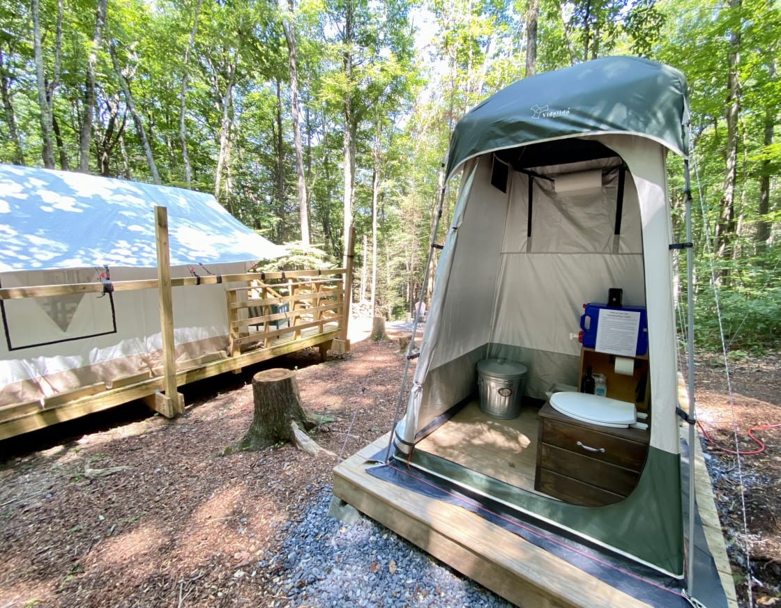 Private, comfortable, and easy-to-use composting restroom. This includes a gravity sink, soap, towels, toilet tissue, a lantern, and a mirror. 
