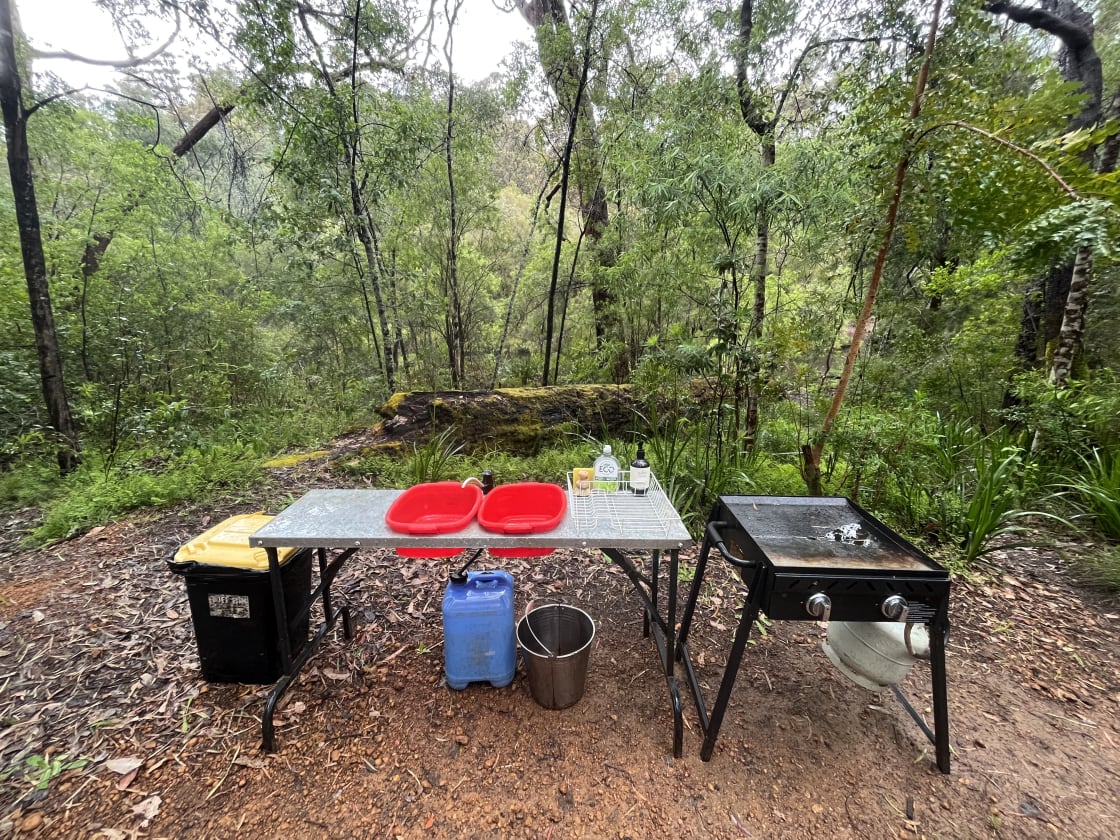Camp kitchen made easy! Washing water provided with a metal bucket to make warming water easy.