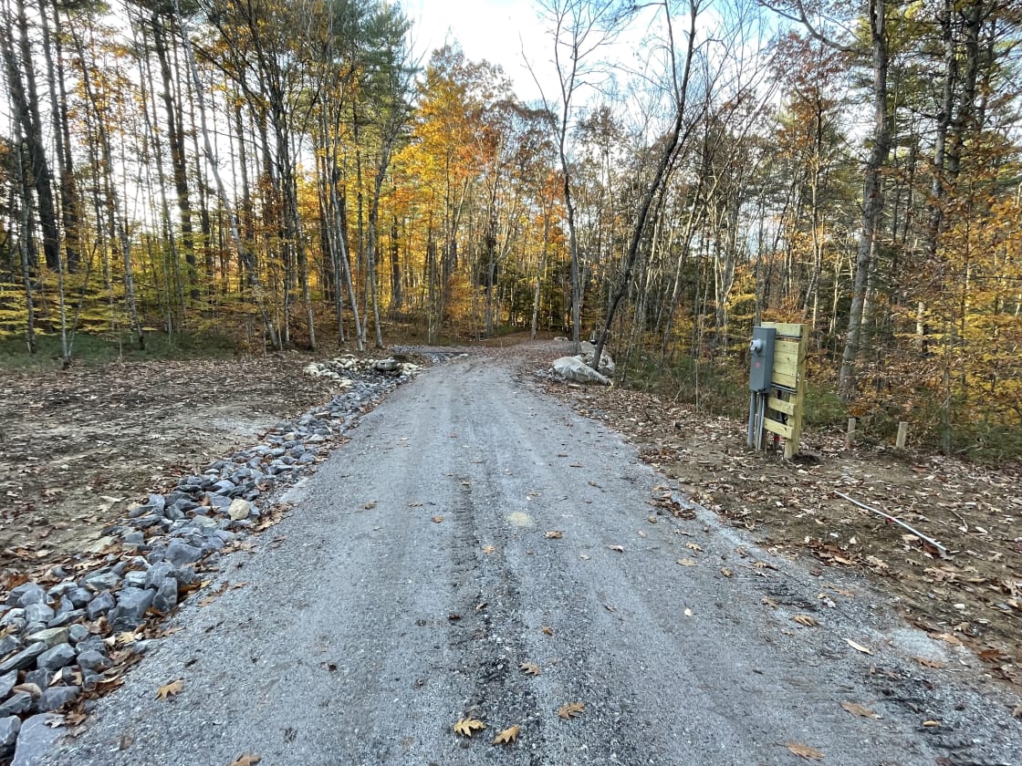 Your view as you back into your site.  On the right is the electric meter base station that feeds power to the RV Pad power station.  Continuing straight back is your choice of two crushed granite pads.