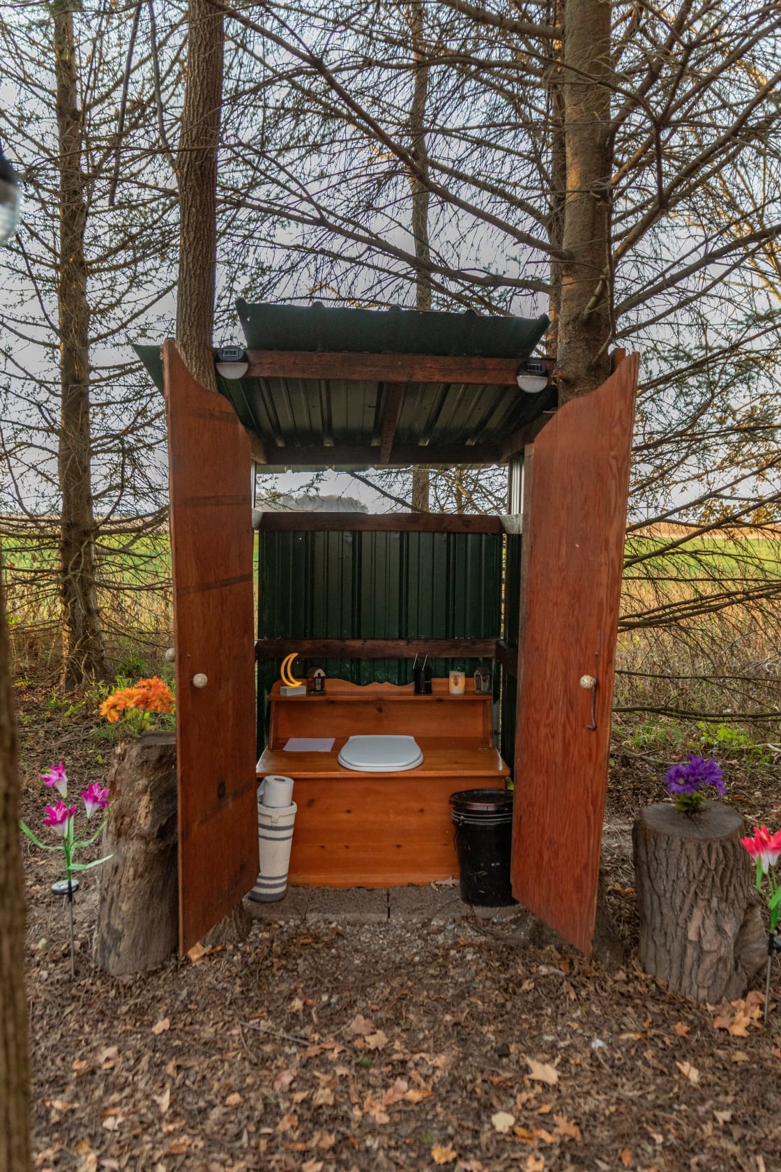 The composting toilet outhouse with lights that turn on at night.