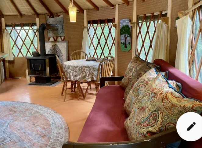 Paisley Paradise Yurt has a queen size bed and Daybed, dining table and wood stove