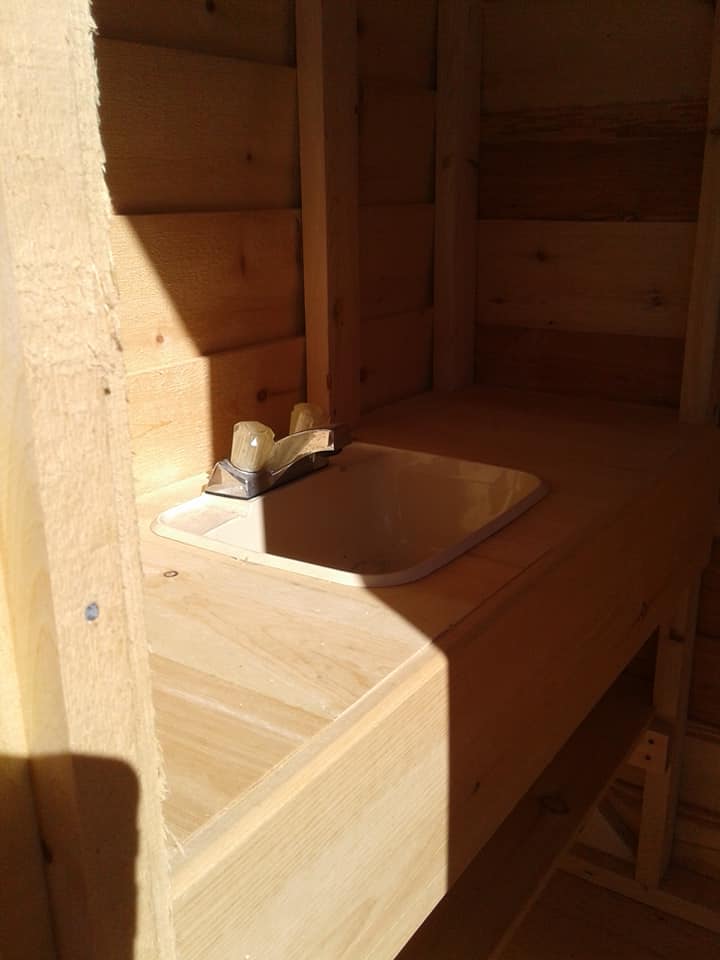 Sink inside the outhouse building.